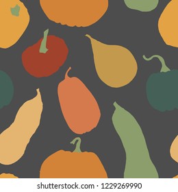 Seamless pumpkin pattern design. Colorful pumpkins on dark background. Autumn hand drawn elements in rustic vintage color palette.