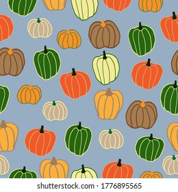 Seamless pumpkin pattern . Grey background, funny colored pumpkins. The print is well suited for packaging.