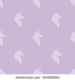 seamless purple fantasy pattern with   silhouette of unicorns head. vector flat Magic creative ornament on violet background