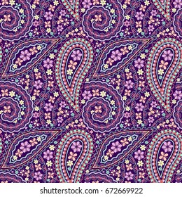 Seamless purple pattern with paisley and geometric symbols. Colorful ethnic ornament, bright print. Vector background. Use for wallpaper, textile design.