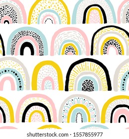 Seamless rainbow pattern. Childish colorful hand-drawn background. Trendy illustration in Scandinavian style. Ideal for printing fabric, textile, wrapping paper.
