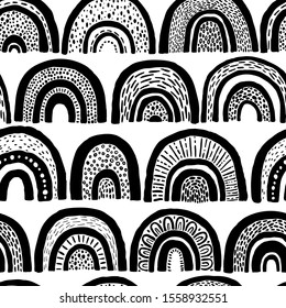 Seamless rainbow pattern. Childish monochrome hand-drawn background. Trendy illustration in Scandinavian style. Ideal for printing fabric, textile, wrapping paper.