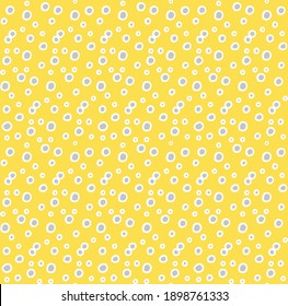 Seamless random outlined grey polka pattern on yellow background. Irregular chaotic points. Vector graphic. Abstract scattered dots wallpaper. Simple, modern decorative print on wrapping paper, fabric