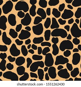 Seamless repeat pattern with abstract animal spots pattern in black and tan