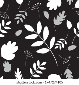 Seamless repeat pattern of autumn foliage leaves, berries white and grey silhouettes on a black background.  Tile, wallpaper, fabric design, surface pattern