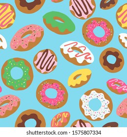 Seamless repeat pattern with colourful colorful donuts doughnuts with sprinkles and icing tossed on a blue background