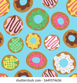 Seamless repeat pattern with colourful colorful donuts doughnuts with sprinkles and icing tossed on a blue background