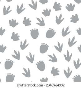 Seamless repeat pattern with different shape gray dinosaur foot prints tracks on a white background. Great for boys and kids designs