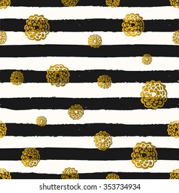 Seamless repeat pattern with gold foil flowers on black and white stripes background. Tiling festive background, greeting card or wrapping paper.