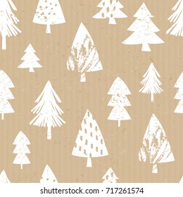 Seamless repeat pattern with hand drawn Christmas trees in white on craft paper background.