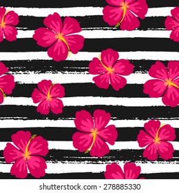 Seamless repeat pattern with hibiscus flowers on a black and white hand drawn brush strokes background.