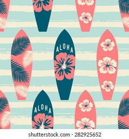 Seamless repeat pattern with surf boards in red and blue on a striped light blue brush strokes background.