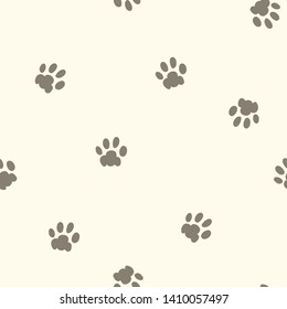 Seamless repeat pattern with taupe dog or cat paw prints on a cream background