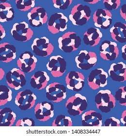 Seamless repeat pattern of a trendy, wildlife animal print in neon, bright pink and purple. Vivid blue background. Limited color palette. Large scale, colorful vector design. Skin spots of leopard.