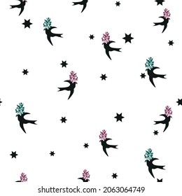 Seamless repeat vector pattern of black birds carrying red and green sprigs on a white background with black stars. Great for fashion, textiles, surface textures, giftwrap, wallpaper.