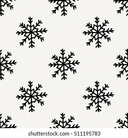 Seamless repeating pattern with hand drawn snowflakes in black and cream. Minimalist festive textile, gift wrap, wall art design.