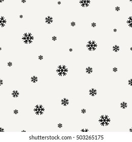 Seamless repeating pattern with snowflakes in black on cream backdrop. Tiling festive background, greeting card or wrapping paper.