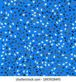 Seamless repeating pattern of terrazzo in blue, yellow, pastel and brown on a dark blue background. Trendy and stylish composite stone texture, wallpaper, web background, fabric design.