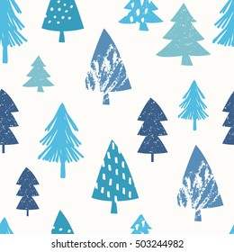 Seamless repeating pattern with textured Christmas trees in different shades of blue on white background.