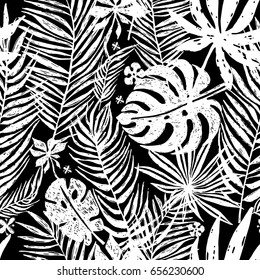 Seamless repeating pattern with white silhouettes of palm tree leaves in black background. Vector botanical illustration, elements for design.