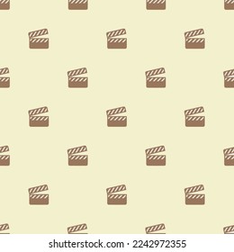 Seamless repeating tiling movie clapper flat icon pattern of platinum and pale brown color. Background for website.