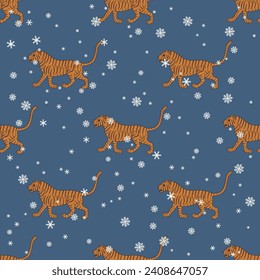 Impresionante patrón invernal estacional con tigres caminantes y copos de nieve. Diseño animal tradicional de la India. Sobre fondo azul.