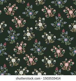 Seamless small flowers on a dark green background
