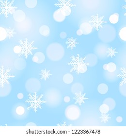 Seamless snowflakes background with boke. Winter light snowflake pattern.
