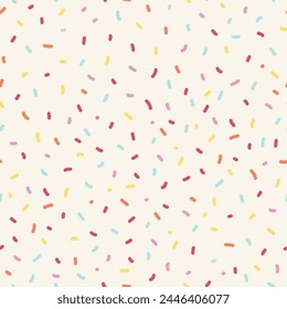 Seamless sprinkle pattern. Colorful background design with cute pastel colored sprinkles. 