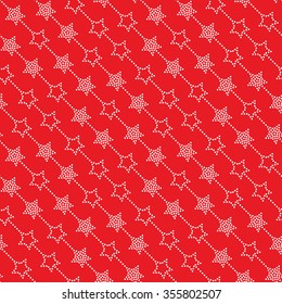 Seamless stars pattern on red background. Chevrons of stars. Dotted star shapes in garlands. Christmas beads pattern. Christmas holiday pattern of garlands.  Vector Regular Texture
