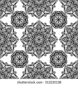 Seamless, symmetrical black pattern on a white background. Oriental ornament of mandalas. Sketch for embroidery.