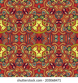 Seamless symmetrical pattern in red, blue and yellow colors. Mandala. Kaleidoscopic design.