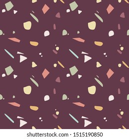 Seamless terrazzo pattern in autumnal colors on burgundy background. Stone texture. Vector illustration, flat design