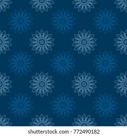 Seamless texture of blue geometric flowers on a blue background