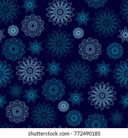 Seamless texture of blue geometric flowers on a blue background
