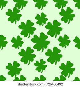 Seamless texture. Clover leaves on a green background