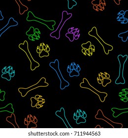 Seamless texture. Colored traces of paws on a black background