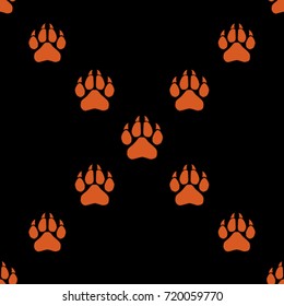 Seamless texture. Colored traces of paws on a black background