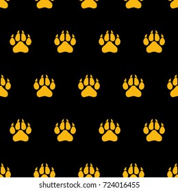 Seamless texture. Colored traces of paws on a black background