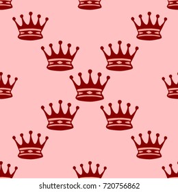 Seamless texture. Crowns on a pink background