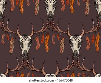 Seamless texture deer skull with horns, feathers and boho pattern. Vector background for your creativity