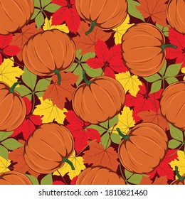 Seamless texture with the image of autumn leaves and pumpkins.