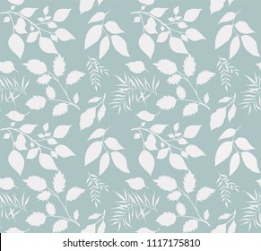 Seamless texture of leaves. White leaves on blue background