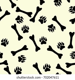 Seamless texture. Silhouette of traces of paws and bones on a yellow background