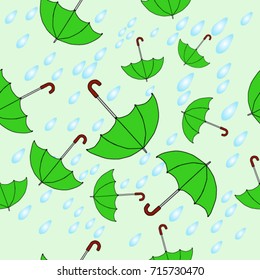 Seamless texture. Umbrellas on a green background
