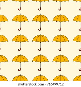Seamless texture. Umbrellas on a yellow background