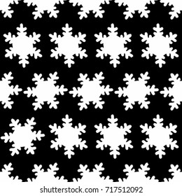 Seamless texture. White snowflakes on a black background