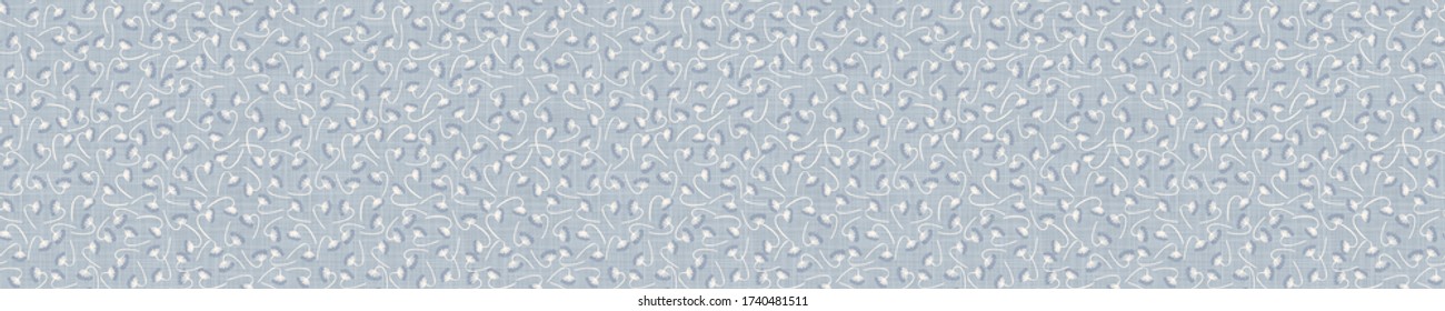 Seamless tossed floral border pattern. French blue linen shabby chic style. Hand drawn country bloom banner. Rustic woven background. Kitchen towel home decor swatch. Simple flower ribbon trim edge.
