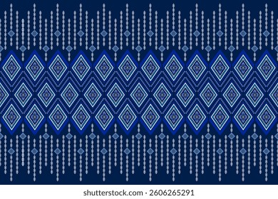 A seamless traditional textile pattern inspired by Southeast Asian motifs with geometric diamond shapes and intricate floral details. Deep navy blue with white and light blue accents.