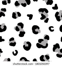 Seamless trend pattern. Black and grey spots of a leopard on a white background. Fashionable print is suitable for Wallpaper and textiles.
